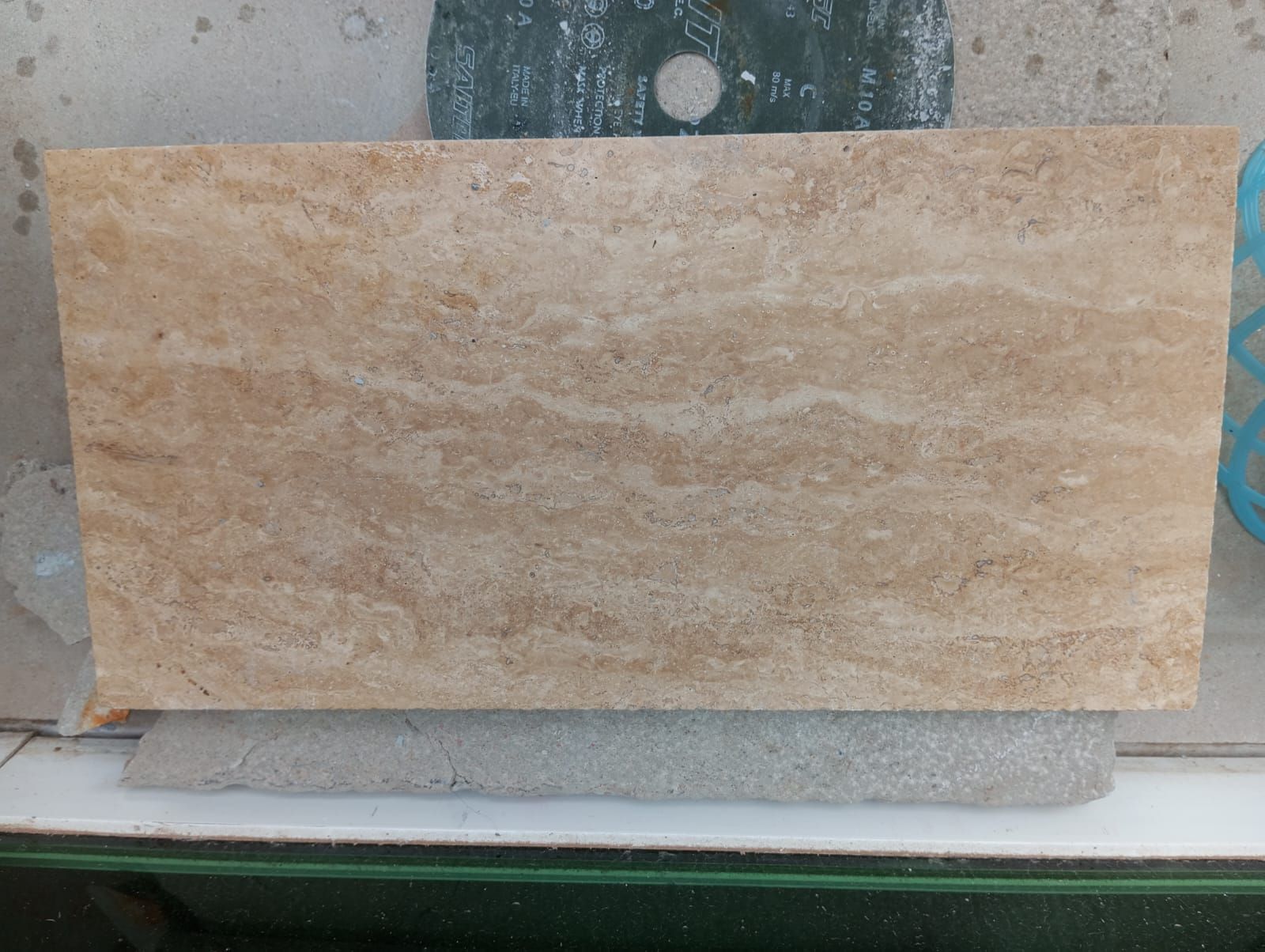 Oyster Travertine (light taupe and beige coloration) that has striated movement