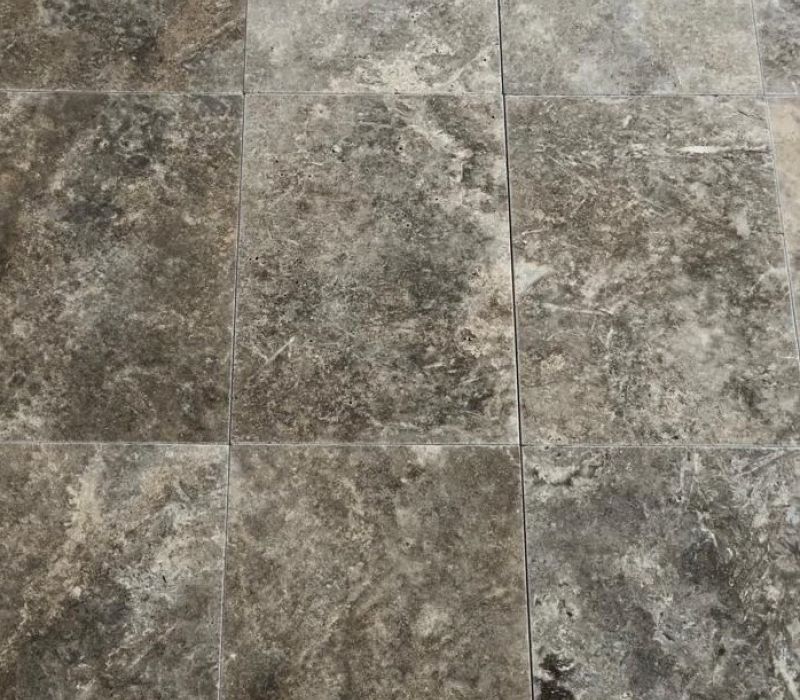 Dark grey, silver, and brown travertine